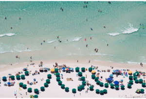 Beach Goers and Green Umbrellas